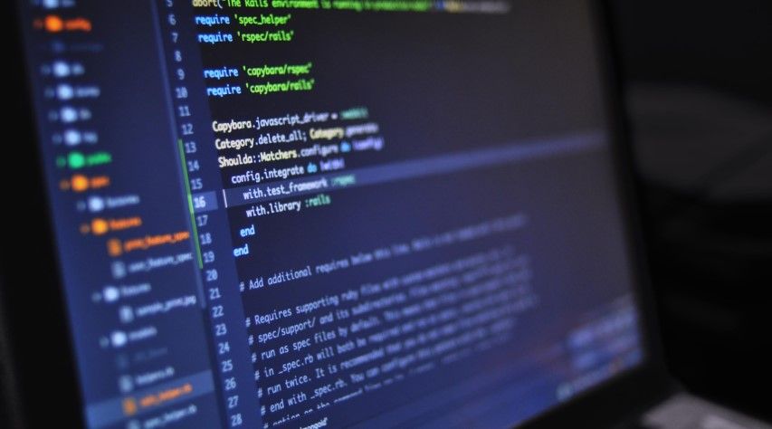 A computer screen displays lines of code in a text editor with highlighted syntax and a visible folder structure on the left side, illustrating how software developers organize projects while protecting code.